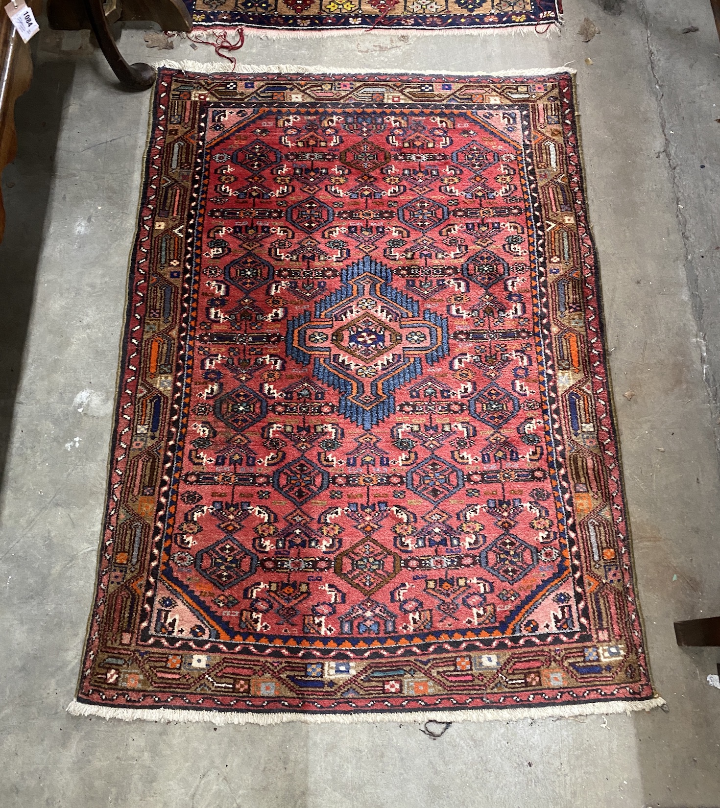 A Caucasian style burgundy ground rug and a North West Persian red ground rug, larger 194 x 106cm